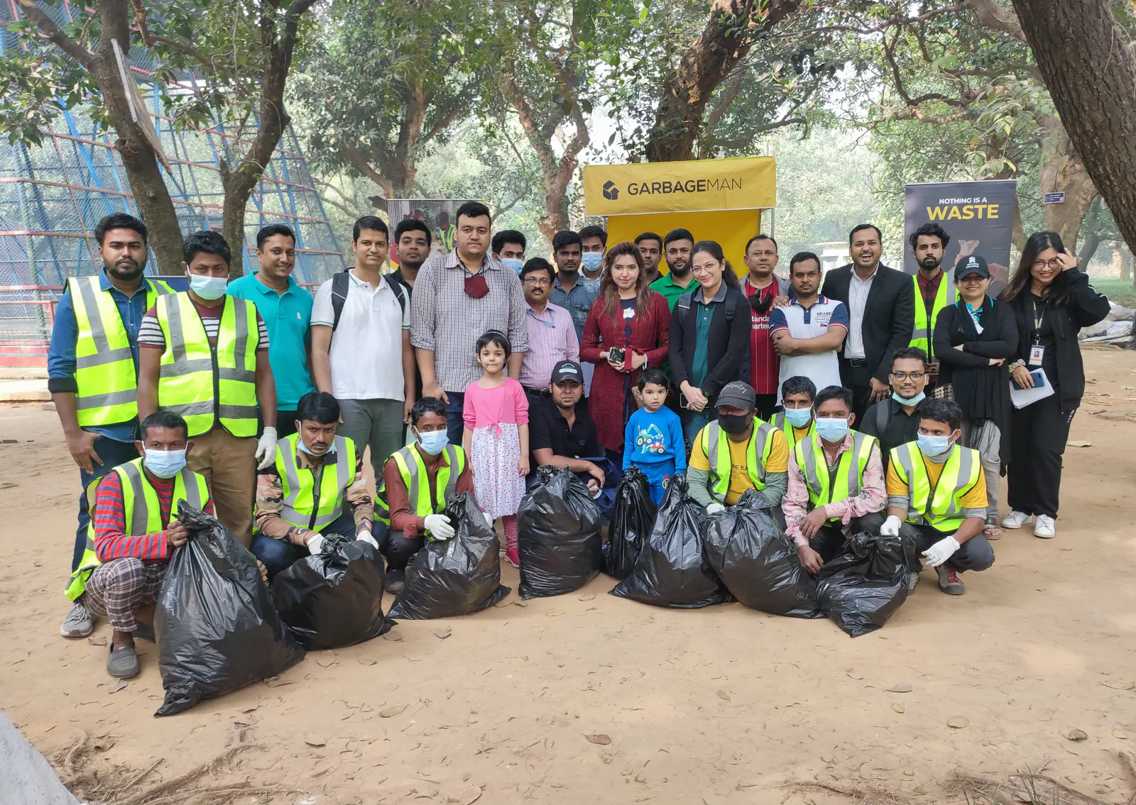Garbageman recovery workers and community participants with collected material after a waste-awareness activity